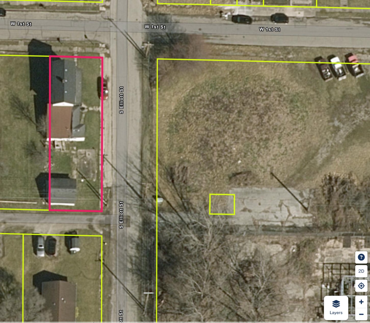 Regrid parcel map — 1001 W 1st St corner parcel outlined at W 1st St and S Elliott St
