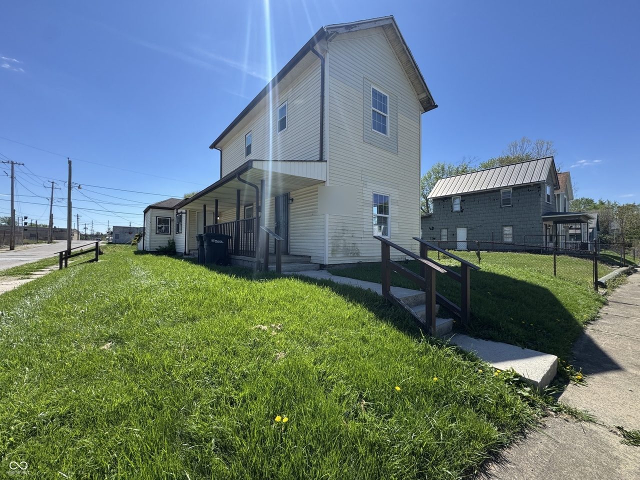 Two-story duplex with covered porch on a corner lot, Muncie Indiana